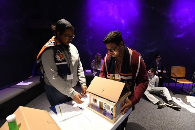 Youth Climate Summit Program participants with model homes.
